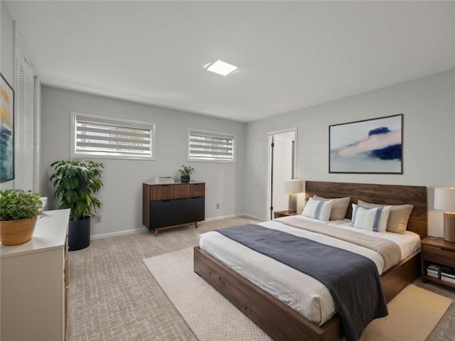 bedroom featuring baseboards and light colored carpet