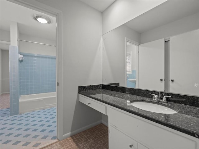 full bathroom with shower / bathing tub combination, vanity, and baseboards