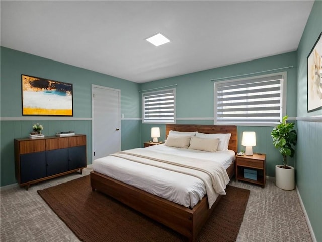 carpeted bedroom with wainscoting