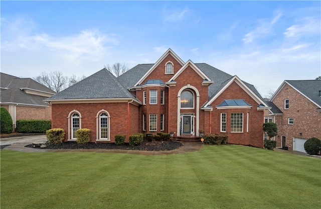 front of property with a garage and a front lawn