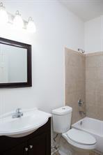 full bathroom with vanity, toilet, and tiled shower / bath