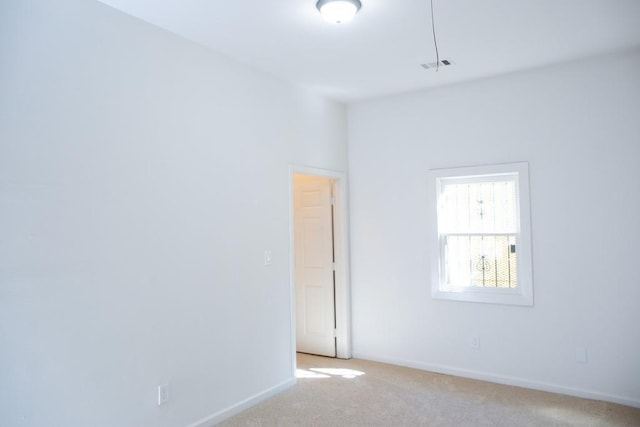 empty room with light colored carpet