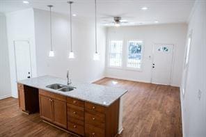 kitchen featuring decorative light fixtures, sink, ceiling fan, and dark wood-type flooring