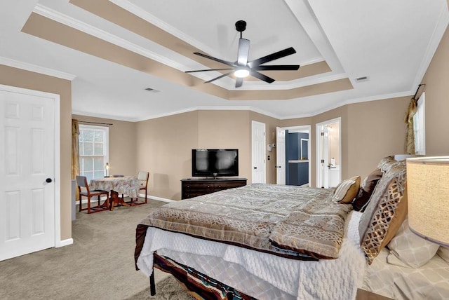 carpeted bedroom featuring ceiling fan, ornamental molding, and a tray ceiling