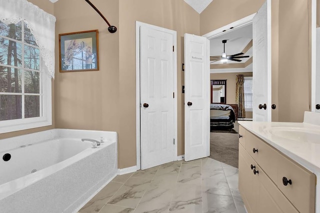 bathroom featuring a bathtub, ceiling fan, and vanity