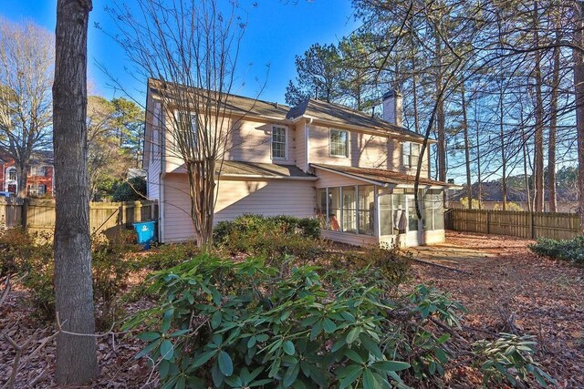 back of property featuring a sunroom