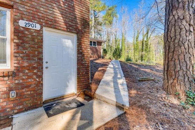 entrance to property with brick siding