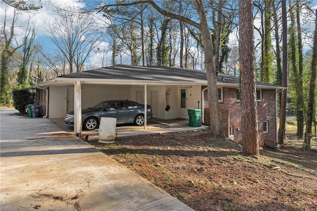 view of parking featuring a carport and concrete driveway