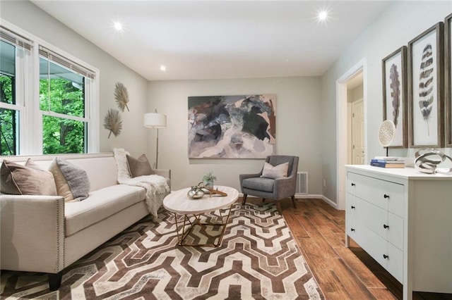 living room with recessed lighting, wood finished floors, visible vents, and baseboards