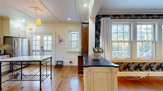 kitchen with pendant lighting, french doors, stainless steel fridge, light wood-type flooring, and cream cabinetry