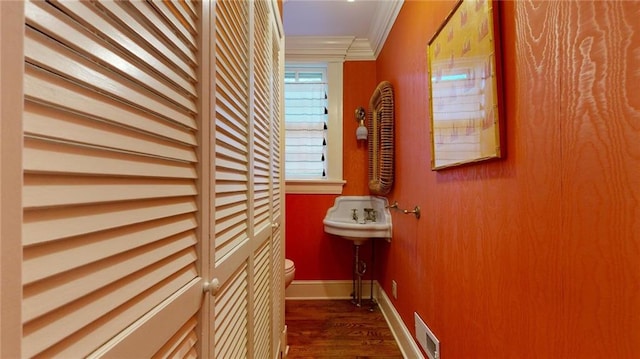 hall featuring crown molding and dark wood-type flooring