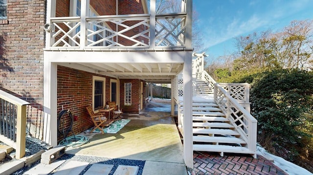 view of side of property with a patio area and a balcony