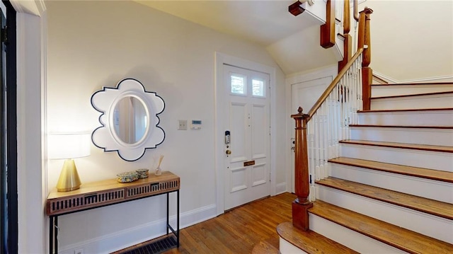 foyer entrance featuring hardwood / wood-style flooring and lofted ceiling