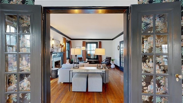 living room with ornamental molding and wood-type flooring