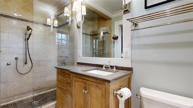 bathroom featuring vanity, ornamental molding, toilet, and a tile shower