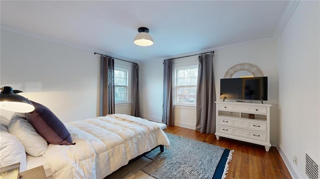 bedroom featuring crown molding and dark hardwood / wood-style flooring