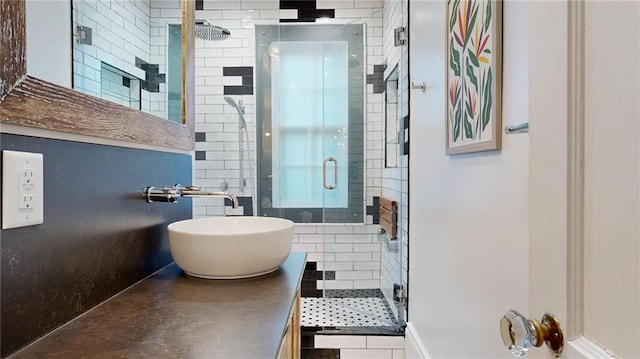 bathroom with vanity and a shower with door