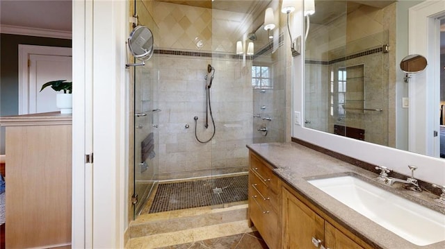 bathroom with walk in shower, ornamental molding, and vanity