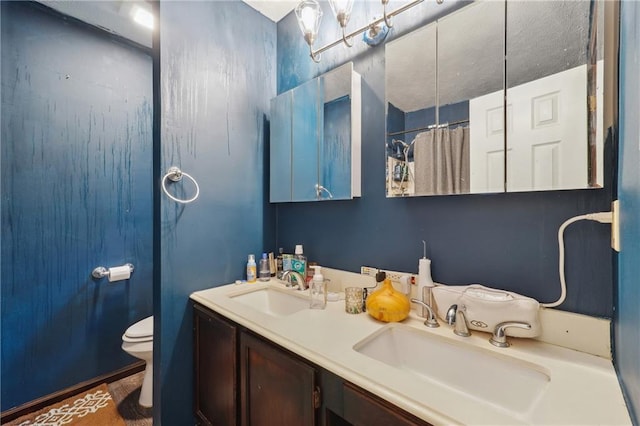 bathroom featuring walk in shower, vanity, and toilet