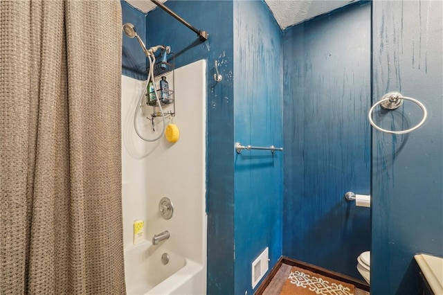 bathroom with toilet and shower / bath combo with shower curtain