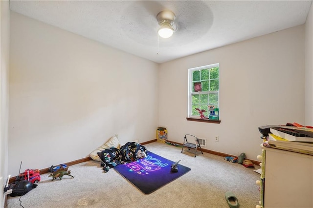 interior space with carpet and ceiling fan