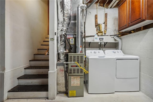 laundry room featuring cabinets and separate washer and dryer