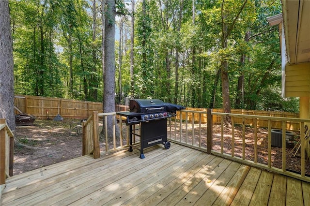 wooden terrace featuring area for grilling and central air condition unit