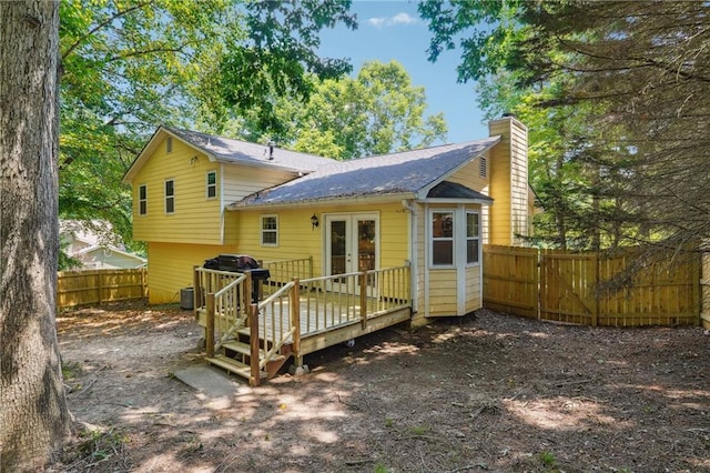 back of property featuring french doors and a deck