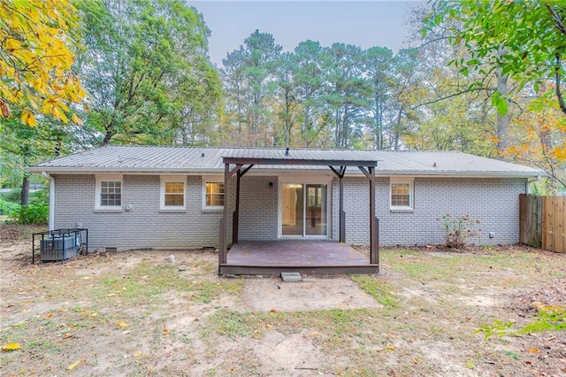 back of house with central AC unit and a wooden deck