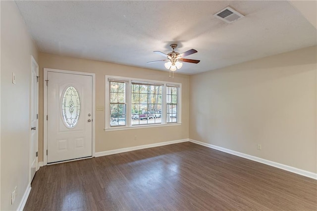 entryway featuring ceiling fan, dark hardwood / wood-style floors, and a textured ceiling