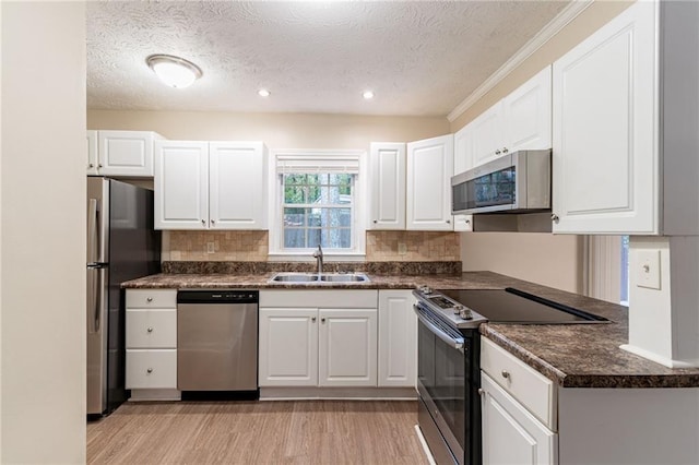 kitchen with white cabinetry, sink, and stainless steel appliances