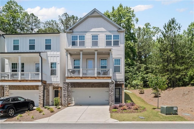 507 Bishop Ln, Woodstock, GA 30188 - view of front of house featuring a garage, driveway, stone siding, and board and batten siding
