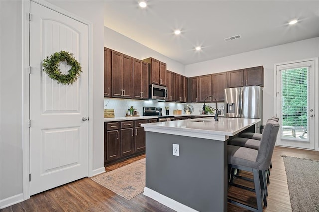 507 Bishop Ln, Woodstock, GA 30188 - kitchen with appliances with stainless steel finishes, a sink, dark wood-type flooring, light countertops, and recessed lighting
