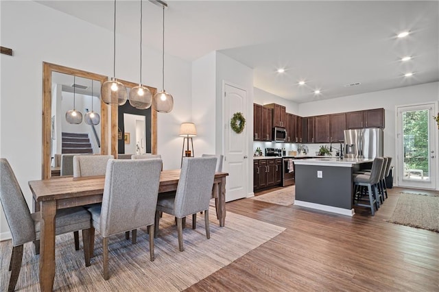 507 Bishop Ln, Woodstock, GA 30188 - dining space featuring stairway, light wood-style flooring, and recessed lighting