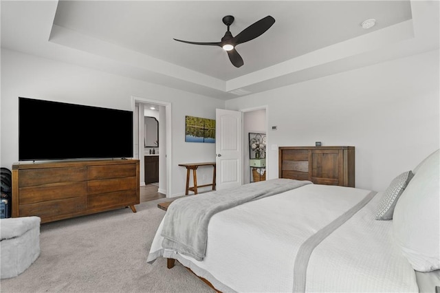 507 Bishop Ln, Woodstock, GA 30188 - bedroom with a raised ceiling, light carpet, connected bathroom, and a ceiling fan