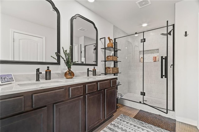 507 Bishop Ln, Woodstock, GA 30188 - full bathroom with a shower stall, wood finished floors, and double vanity