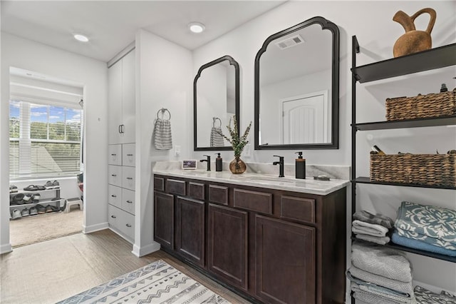 507 Bishop Ln, Woodstock, GA 30188 - full bath featuring double vanity, wood finished floors, recessed lighting, and baseboards