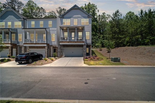 507 Bishop Ln, Woodstock, GA 30188 - townhome / multi-family property featuring stone siding, driveway, and an attached garage