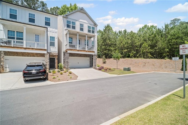 507 Bishop Ln, Woodstock, GA 30188 - view of front of home with driveway, a garage, board and batten siding, and stone siding