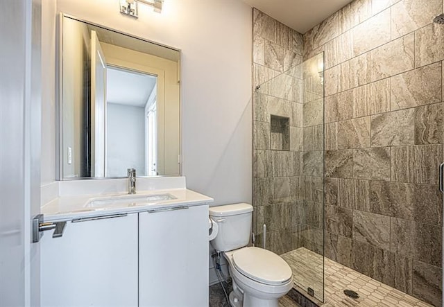 full bath featuring a shower stall, toilet, and vanity