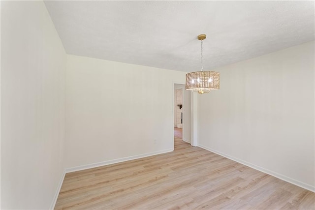 145 Devilla Trce, Fayetteville, GA 30214 - spare room with a chandelier, light wood-type flooring, and baseboards