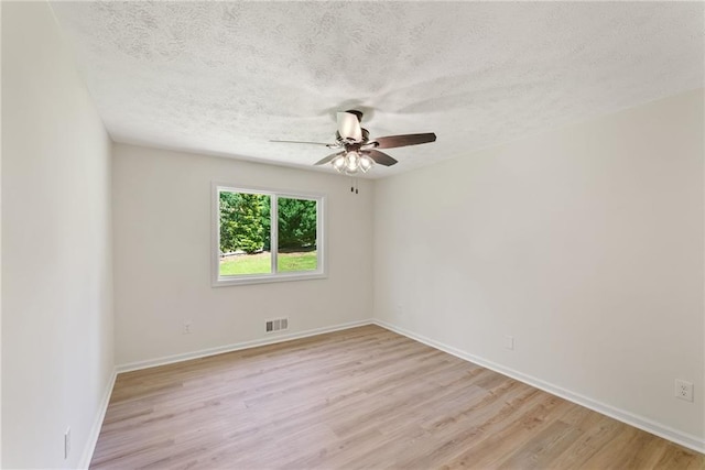 145 Devilla Trce, Fayetteville, GA 30214 - unfurnished room featuring a ceiling fan, light wood finished floors, a textured ceiling, and baseboards