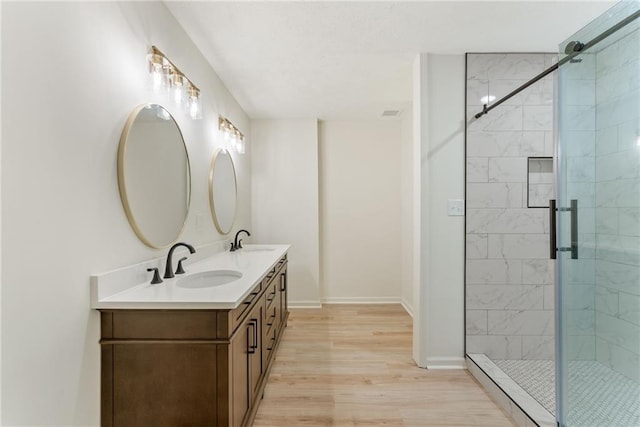 145 Devilla Trce, Fayetteville, GA 30214 - full bathroom with double vanity, wood finished floors, a stall shower, and baseboards