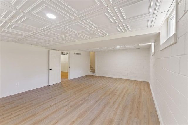 145 Devilla Trce, Fayetteville, GA 30214 - finished below grade area with light wood-style floors, concrete block wall, and stairway