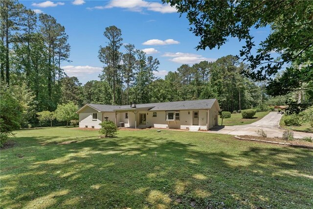145 Devilla Trce, Fayetteville, GA 30214 - rear view of property with a lawn, concrete driveway, and central AC