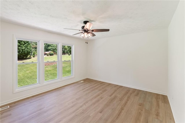 145 Devilla Trce, Fayetteville, GA 30214 - empty room featuring light wood-style floors, baseboards, a ceiling fan, and a textured ceiling