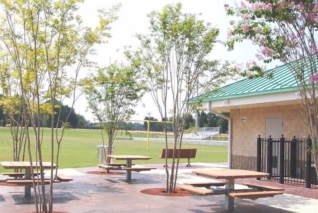 view of community with a lawn and a patio