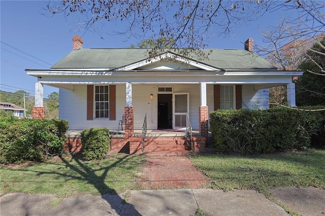 view of front of house with a front lawn and a porch