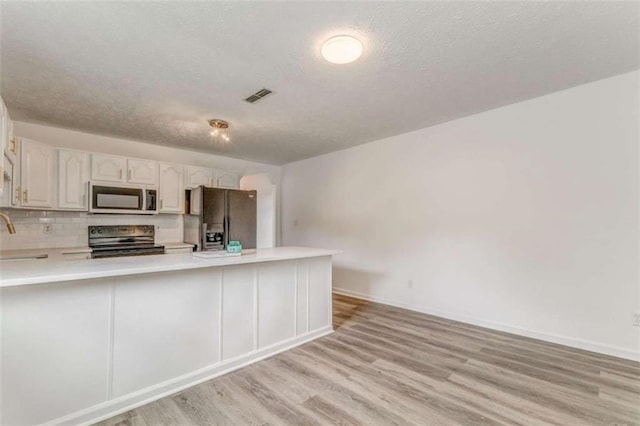 53 Knight Dr, Cedartown, GA 30125 - kitchen with stainless steel microwave, refrigerator with ice dispenser, black range with electric stovetop, light countertops, and light wood-type flooring