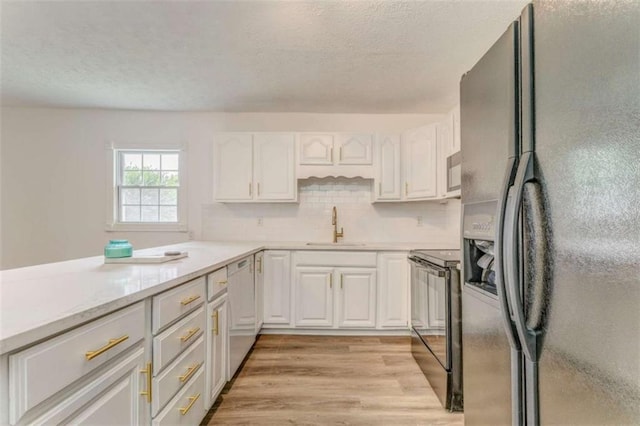 53 Knight Dr, Cedartown, GA 30125 - kitchen featuring black appliances, white cabinetry, a textured ceiling, light wood-style floors, and backsplash